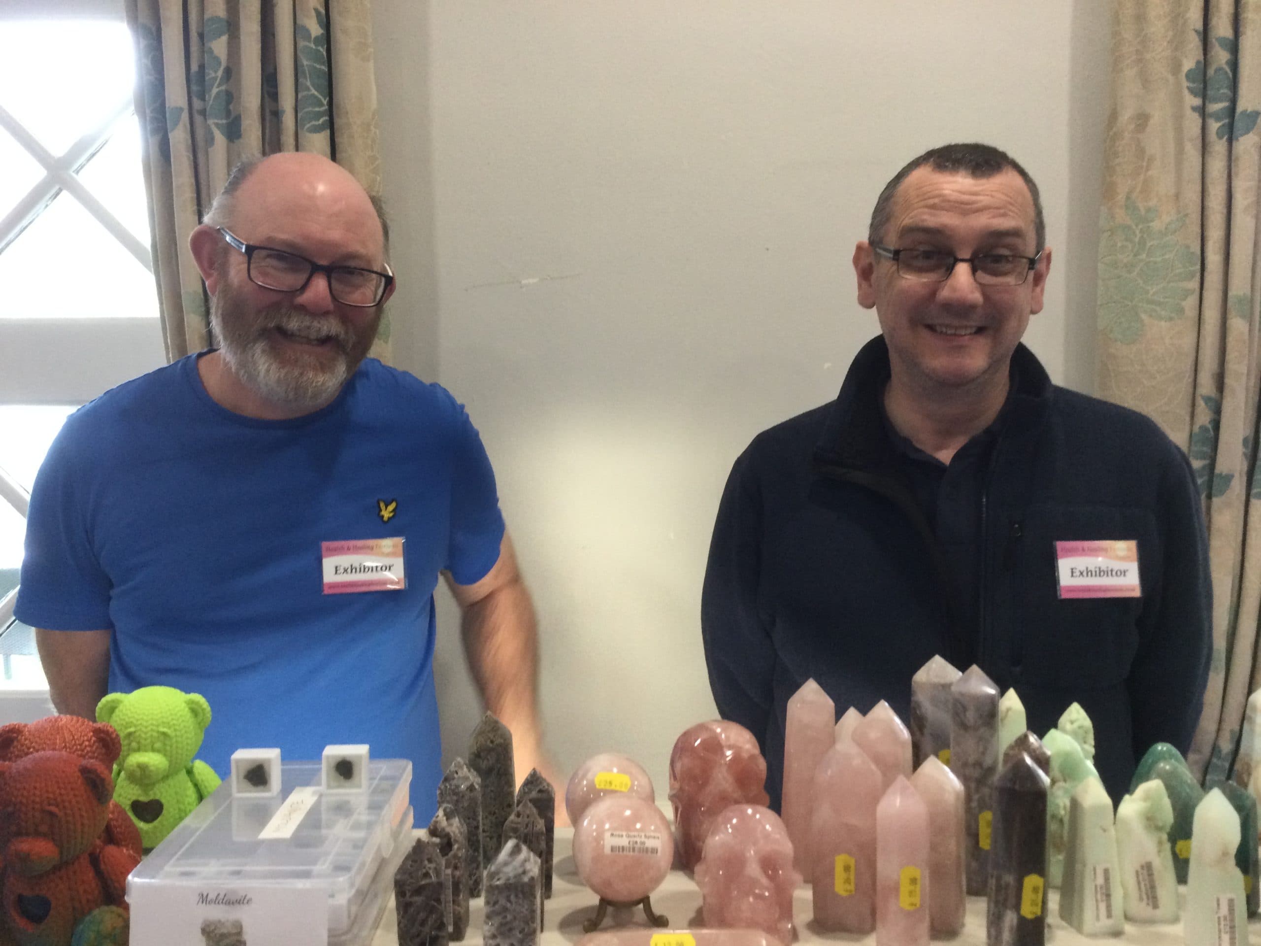 Two exhibitors with rose quartz and crystal towers